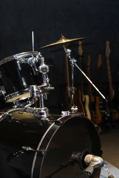 Part of a drum kit with cymbals in a music studio, on stage. Background for photos with live music, rock. Vertical photo