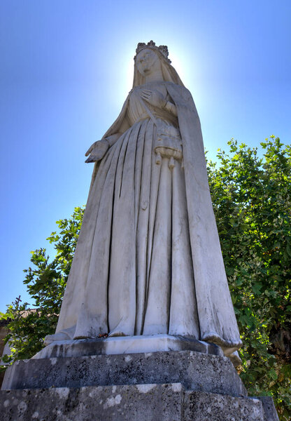 Coimbra, Portugal - August 15, 2022: Statue of Queen Saint Isabel outside Santa Clara-a-Nova Monastery