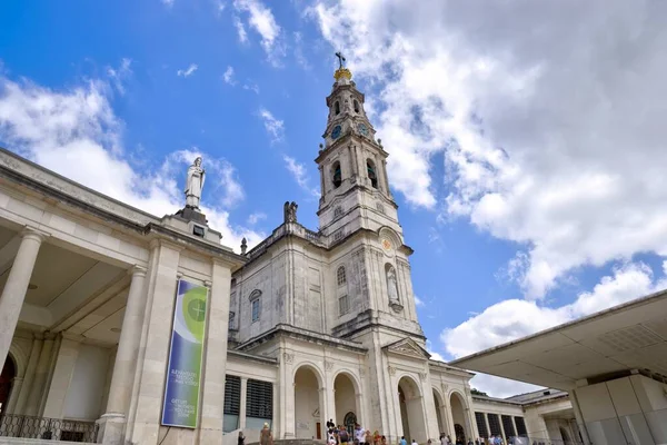 stock image Fatima, Portugal - August 15, 2022: Sanctuary of Our Lady of the Rosary of Fatima Basilica with numerous tourists and pilgrims some motion blurred in foreground