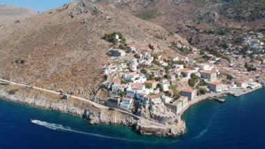 Hava aracı, gün batımında pitoresk liman ve Hydra (veya Ydra) adasının ana köyünün panoramik fotoğrafını çeker. Hydra, Yunanistan 'ın Saronik Körfezi' nde bulunan neoklasik evleri ile önde gelen turizm merkezlerinden biri..