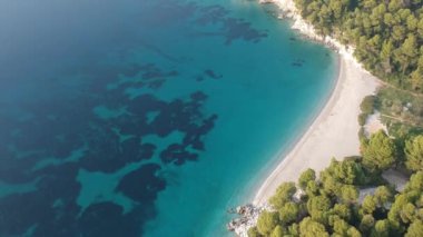 Aerial panoramic view over Milia beach in Skopelos island, against a cloudy sky in Sporades, Greece