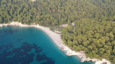 Aerial panoramic view over Milia beach in Skopelos island, against a cloudy sky in Sporades, Greece