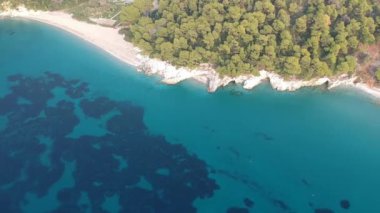 Aerial panoramic view over Milia beach in Skopelos island, against a cloudy sky in Sporades, Greece