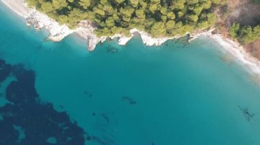 Aerial panoramic view over Milia beach in Skopelos island, against a cloudy sky in Sporades, Greece