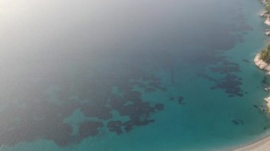 Aerial panoramic view over Milia beach in Skopelos island, against a cloudy sky in Sporades, Greece