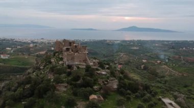 Aerial view of the Castle of Vatika or Castle of Agia Paraskevi at sunset. The castle is located in Mesohori village and has a wonderful view of Neapolis town and Elafonissos island, Laconia, Greece.