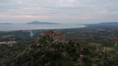 Aerial view of the Castle of Vatika or Castle of Agia Paraskevi at sunset. The castle is located in Mesohori village and has a wonderful view of Neapolis town and Elafonissos island, Laconia, Greece.