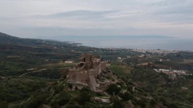 Aerial view of the Castle of Vatika or Castle of Agia Paraskevi at sunset. The castle is located in Mesohori village and has a wonderful view of Neapolis town and Elafonissos island, Laconia, Greece.