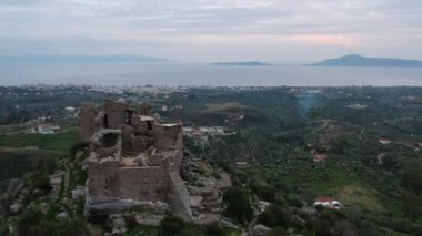 Aerial view of the Castle of Vatika or Castle of Agia Paraskevi at sunset. The castle is located in Mesohori village and has a wonderful view of Neapolis town and Elafonissos island, Laconia, Greece.