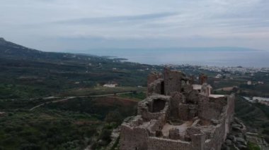 Aerial view of the Castle of Vatika or Castle of Agia Paraskevi at sunset. The castle is located in Mesohori village and has a wonderful view of Neapolis town and Elafonissos island, Laconia, Greece.