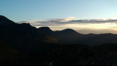 Aerial panoramic view over the picturesque village Papigo in Epirus, Greece at sunset. Scenic aerial view of traditional Greek villages in Autumn. Epirus, Greece, Europe.