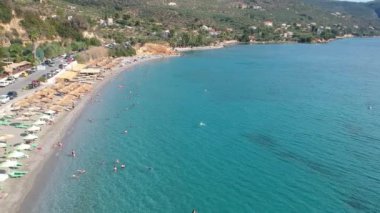Aerial view over Santova coastal area in Messinia, Greece. Summer scenery with beautiful seaside bars and tourists in Santova near Kalamata city, Greece