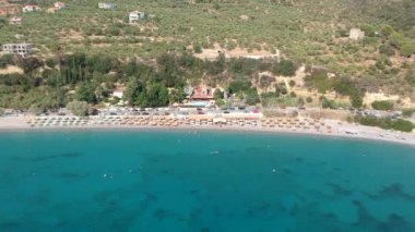 Aerial view over Santova coastal area in Messinia, Greece. Summer scenery with beautiful seaside bars and tourists in Santova near Kalamata city, Greece