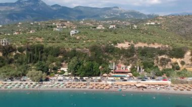 Aerial view over Santova coastal area in Messinia, Greece. Summer scenery with beautiful seaside bars and tourists in Santova near Kalamata city, Greece