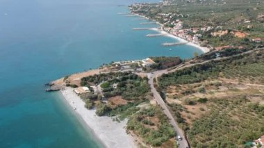 Aerial view over Santova coastal area in Messinia, Greece. Summer scenery with beautiful seaside bars and tourists in Santova near Kalamata city, Greece