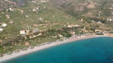 Aerial view over Santova coastal area in Messinia, Greece. Summer scenery with beautiful seaside bars and tourists in Santova near Kalamata city, Greece