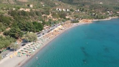 Aerial view over Santova coastal area in Messinia, Greece. Summer scenery with beautiful seaside bars and tourists in Santova near Kalamata city, Greece