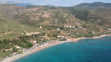 Aerial view over Santova coastal area in Messinia, Greece. Summer scenery with beautiful seaside bars and tourists in Santova near Kalamata city, Greece