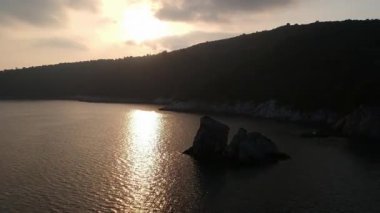 Amazing aerial view over the rocky scenery near Stafilos beach in southern Skopelos island at sunset in Sporades, Greece
