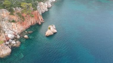 Amazing aerial view over the rocky scenery near Stafilos beach in southern Skopelos island at sunset in Sporades, Greece