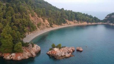 Amazing aerial view over the rocky scenery near Stafilos beach in southern Skopelos island at sunset in Sporades, Greece
