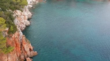 Amazing aerial view over the rocky scenery near Stafilos beach in southern Skopelos island at sunset in Sporades, Greece