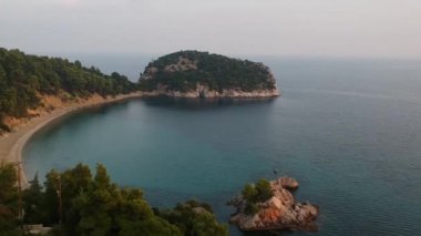 Amazing aerial view over the rocky scenery near Stafilos beach in southern Skopelos island at sunset in Sporades, Greece