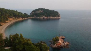 Amazing aerial view over the rocky scenery near Stafilos beach in southern Skopelos island at sunset in Sporades, Greece