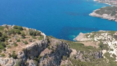 Aerial panorama view over the famous castle of Navarino located on the top of semicircular sandy beach and lagoon, Voidokilia in Messenia, Greece