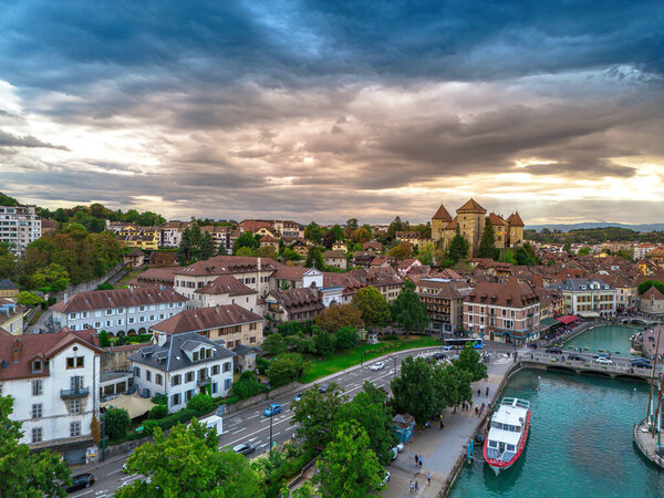 Annecy city center panoramic aerial view over the old town, castle, Thiou river and mountains surrounding the lake. Annecy is known as the Venice of the French Alps, a beautiful summer destination for vacations