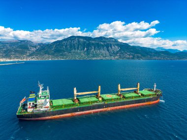 Derin mavi Ege Denizi 'ne demirlenmiş büyük bir yük tankerinin havadan çekilmiş fotoğrafı..