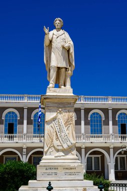 Zakynthos, Greece - June 8 2024: The statue of Dionysios Solomos against a deep blue sky. It is Located in front of Byzantine museum in Solomos square in Zakynthos island in Greece. clipart