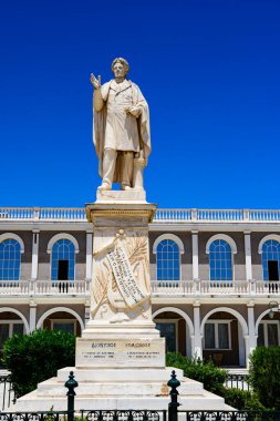 Zakynthos, Greece - June 8 2024: The statue of Dionysios Solomos against a deep blue sky. It is Located in front of Byzantine museum in Solomos square in Zakynthos island in Greece. clipart