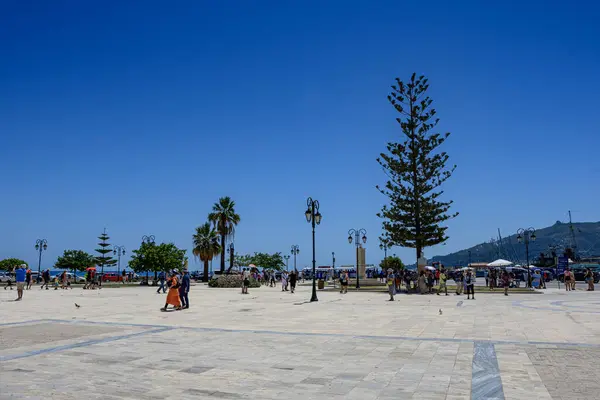 stock image Zakynthos, Greece - June 8 2024: Panoramic urban view of Dionysios Solomos Square in Zakynthos town, against a deep blue summer sky. Zakynthos, Greece