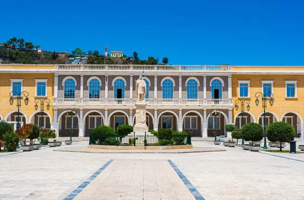 stock image Zakynthos, Greece - June 8 2024: Panoramic urban view of Dionysios Solomos Square in Zakynthos town, against a deep blue summer sky. Zakynthos, Greece