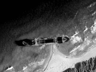 Iconic Top-Down View of a Dramatic Shipwreck in Scenic Waters in black and white clipart