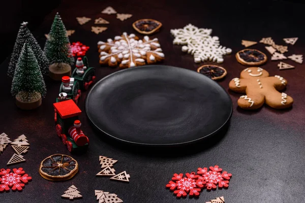 stock image Home festive Christmas table decorated by toys and gingerbreads on a dark concrete background