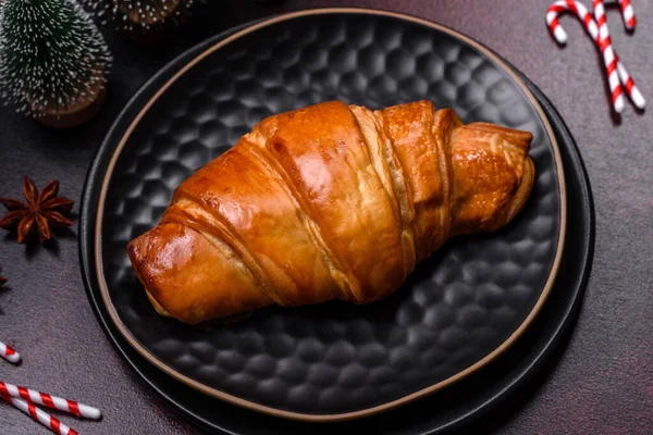 stock image Beautiful different Christmas decorations and croissant on a brown concrete table. Preparation for New Year's celebrations