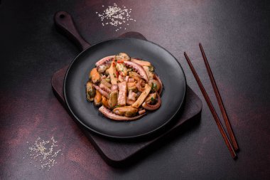 Lezzetli deniz ürünleri salatası ya da siyah tabakta koyu beton bir arka planda kokteyl.