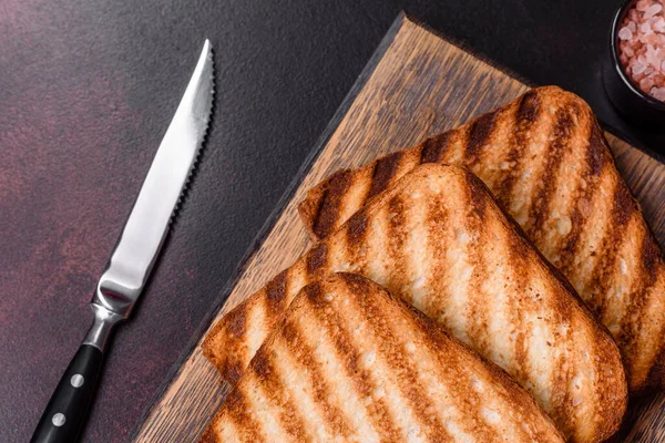 Tasty fresh crispy bread slices in the form of grilled toast for cooking delicious family breakfast