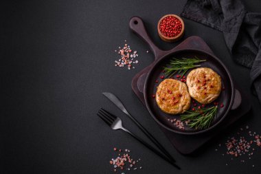 Grilled meatballs with spices and herbs or crepinette on a dark concrete background