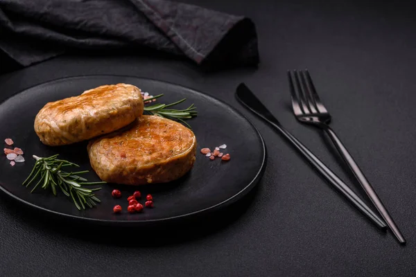 Grilled meatballs with spices and herbs or crepinette on a dark concrete background