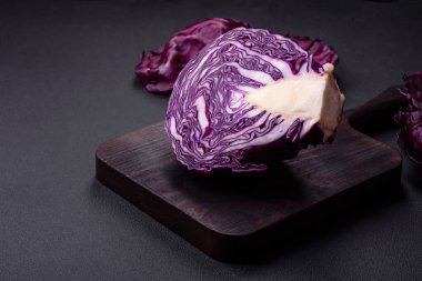 Fresh beautiful red cabbage with textured leaves on a dark concrete background. Vegetarian cooking