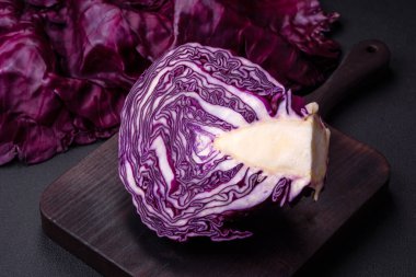 Fresh beautiful red cabbage with textured leaves on a dark concrete background. Vegetarian cooking