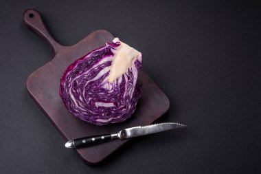 Fresh beautiful red cabbage with textured leaves on a dark concrete background. Vegetarian cooking