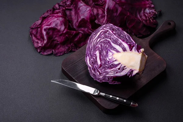 Fresh beautiful red cabbage with textured leaves on a dark concrete background. Vegetarian cooking