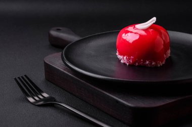 Beautiful tasty cake red color cheesecake in the shape of a heart. Sweets for Valentine's Day