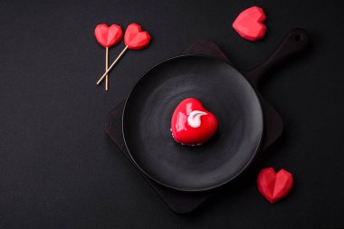 Beautiful tasty cake red color cheesecake in the shape of a heart. Sweets for Valentine's Day