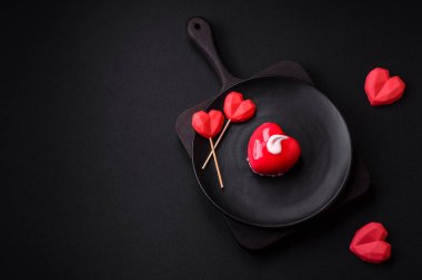 Beautiful tasty cake red color cheesecake in the shape of a heart. Sweets for Valentine's Day