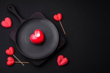 Beautiful tasty cake red color cheesecake in the shape of a heart. Sweets for Valentine's Day